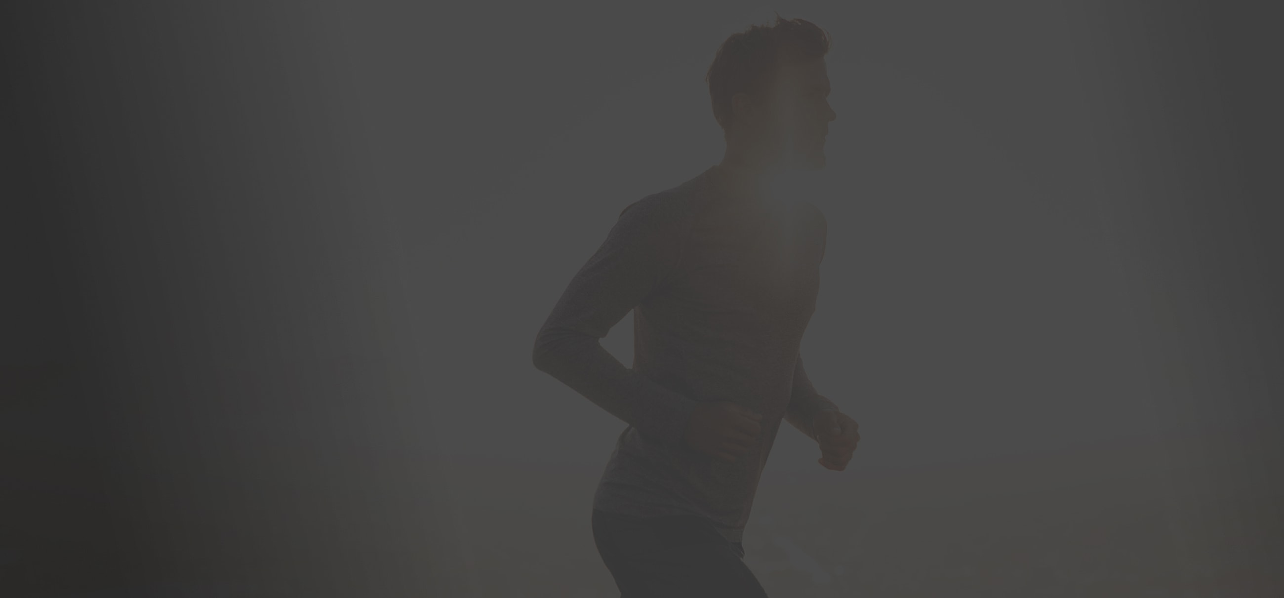 Person jogging in early morning light.