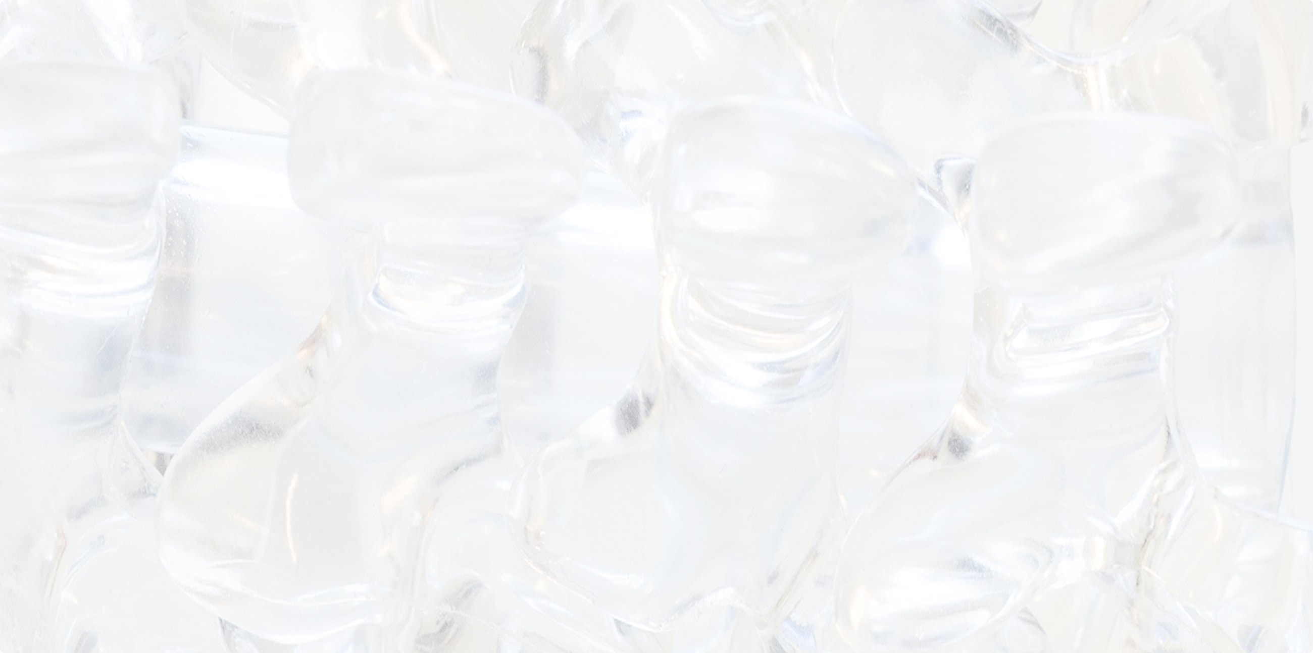Clear plastic boot figurines stacked together.