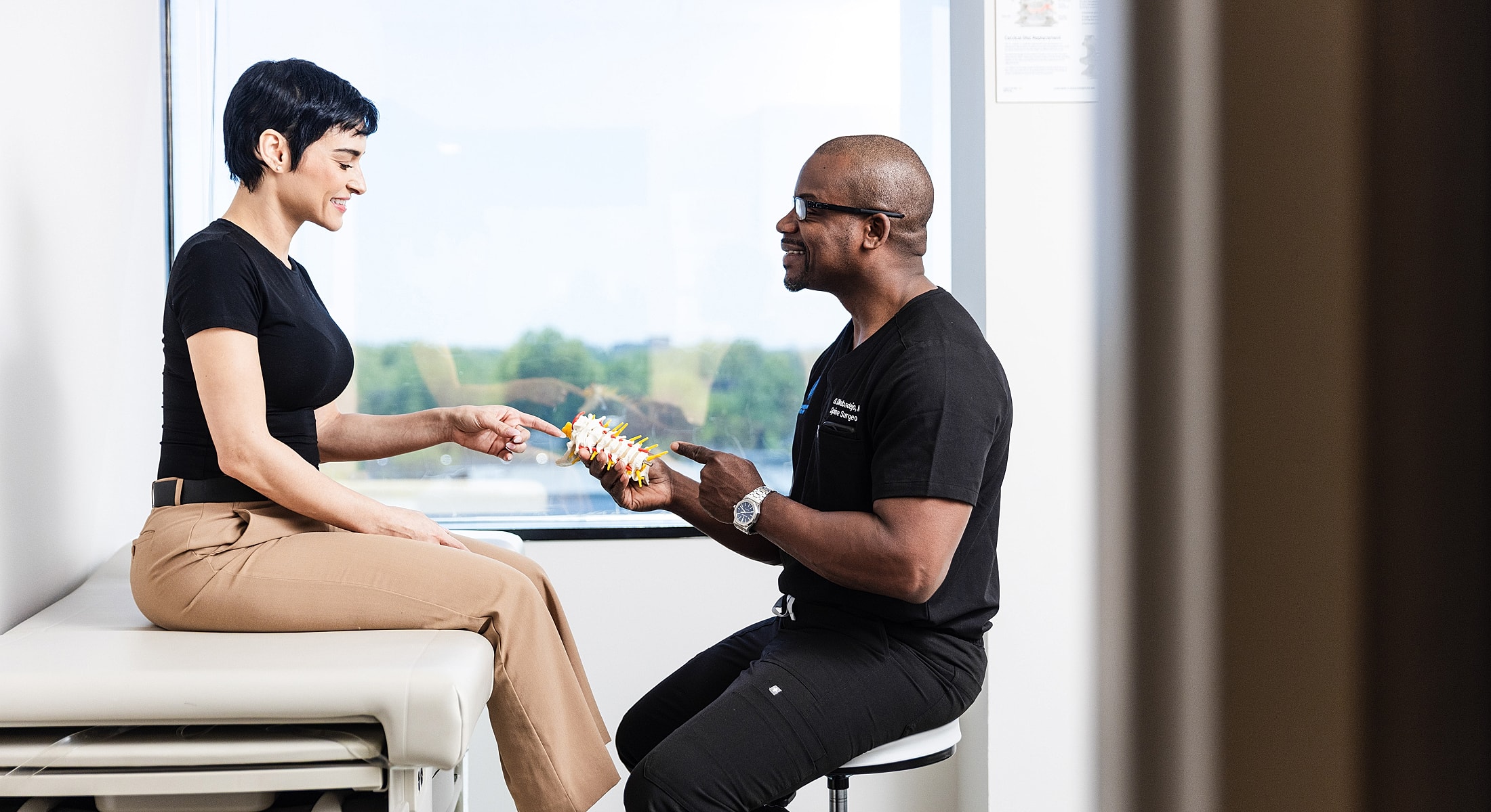 Doctor explaining anatomy to a patient in clinic.