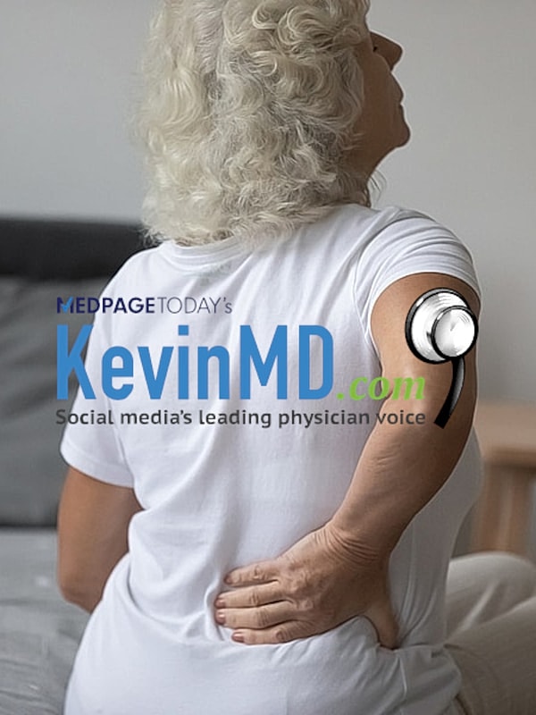 Woman experiencing back pain while sitting.