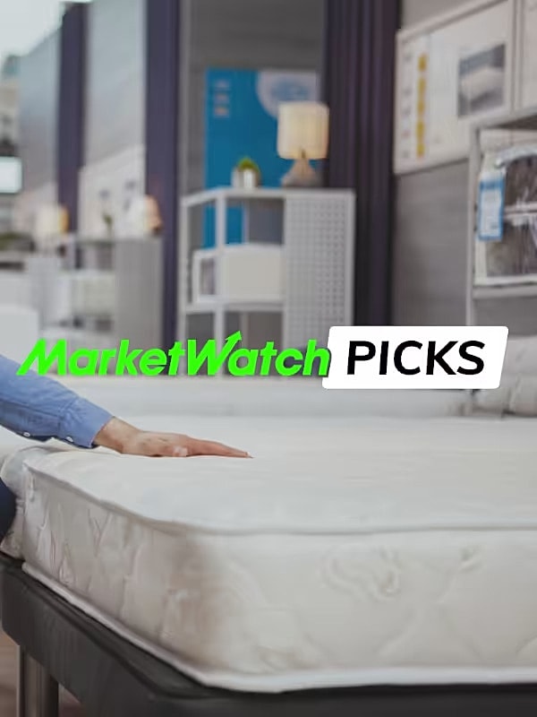 Person testing a comfortable mattress in store.
