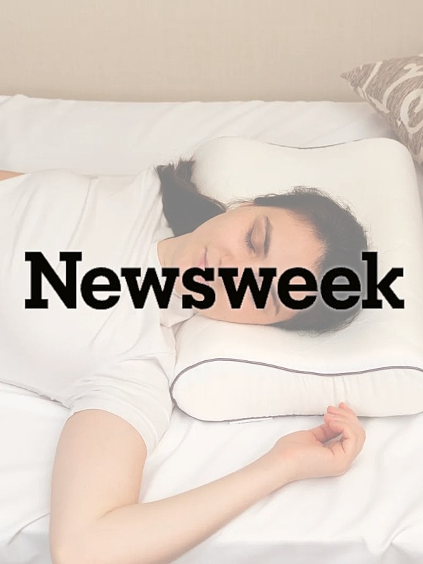 Person sleeping on a pillow in bed.