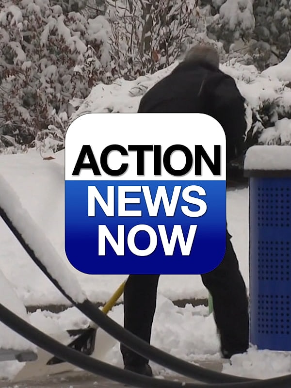 Man shoveling snow in winter scene.