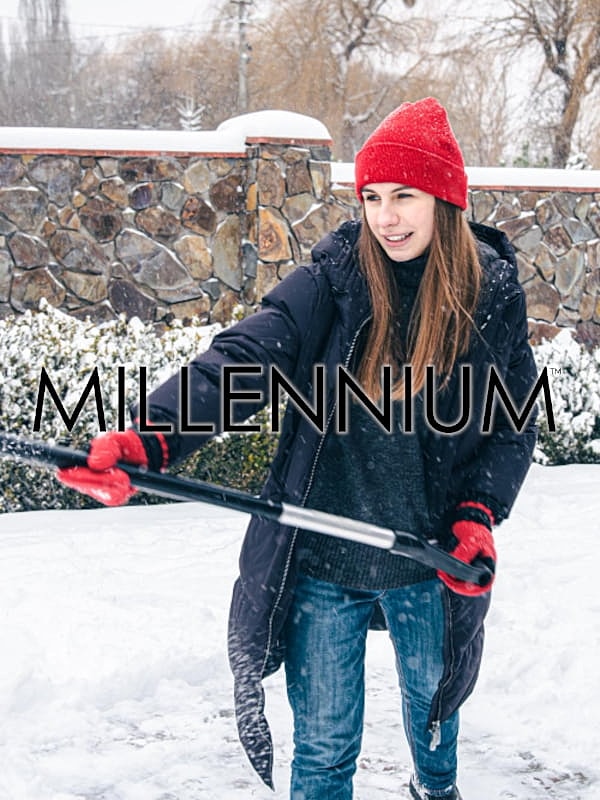 Woman shoveling snow in winter attire.