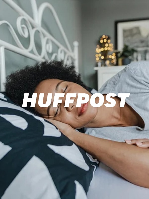 Person sleeping peacefully on a pillow.