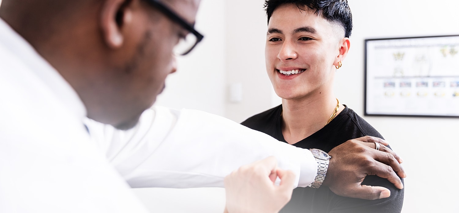 Patient smiling during a spine surgeon consultation.