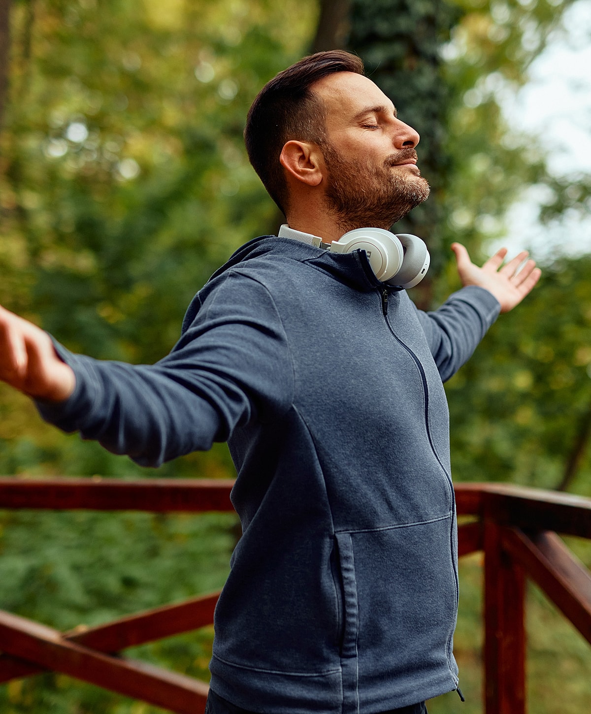 cervical radiculopathy treatment patient model enjoying nature with headphones outdoors.