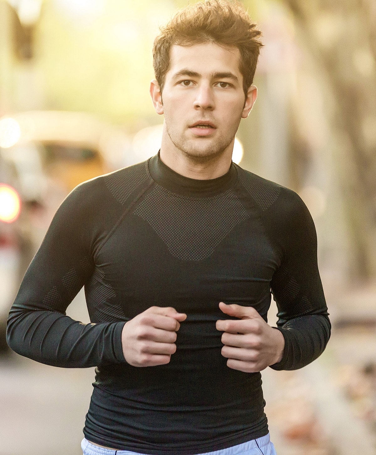 sciatica treatment patient model running outdoors in activewear.