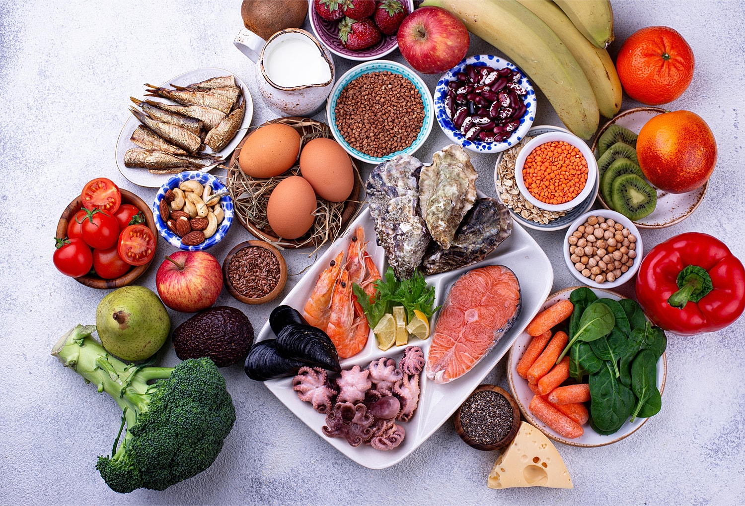 Assorted fresh foods including fruits and seafood.