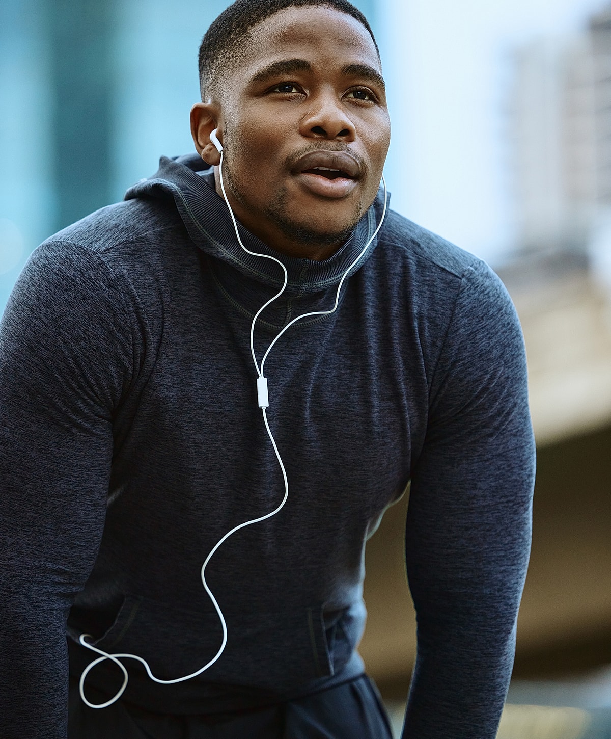 spinal fusion surgery patient model listening to music while exercising outdoors.