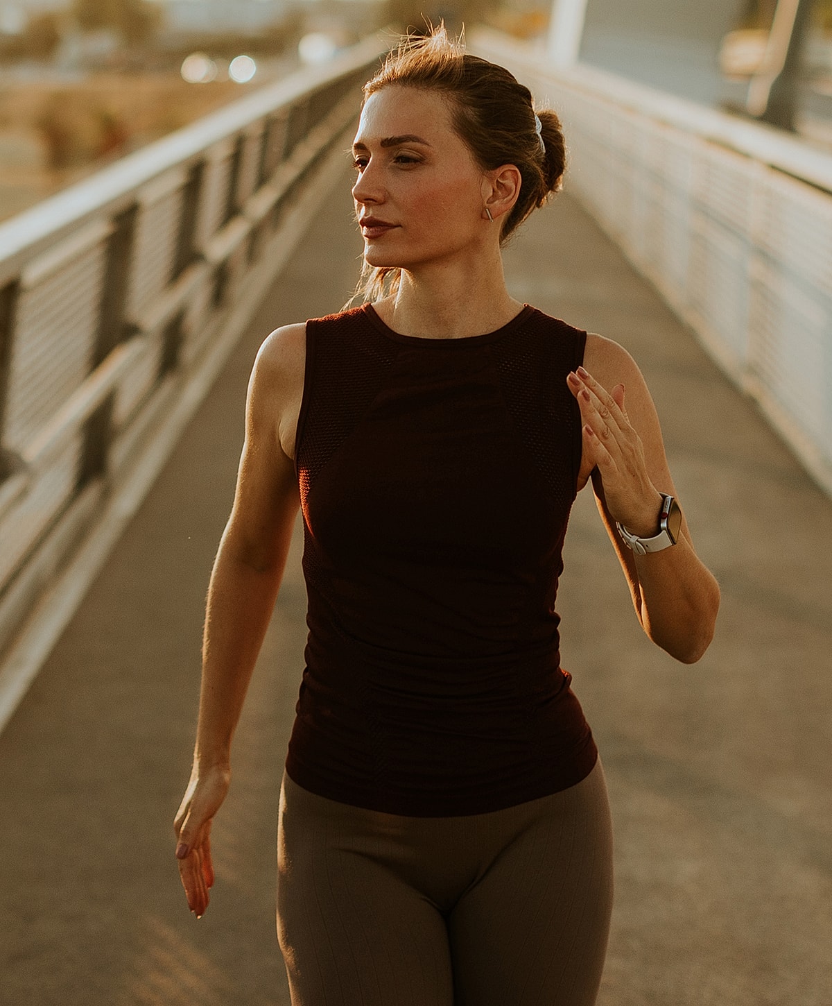 laminectomy surgery patient model jogging on a bridge during sunset.
