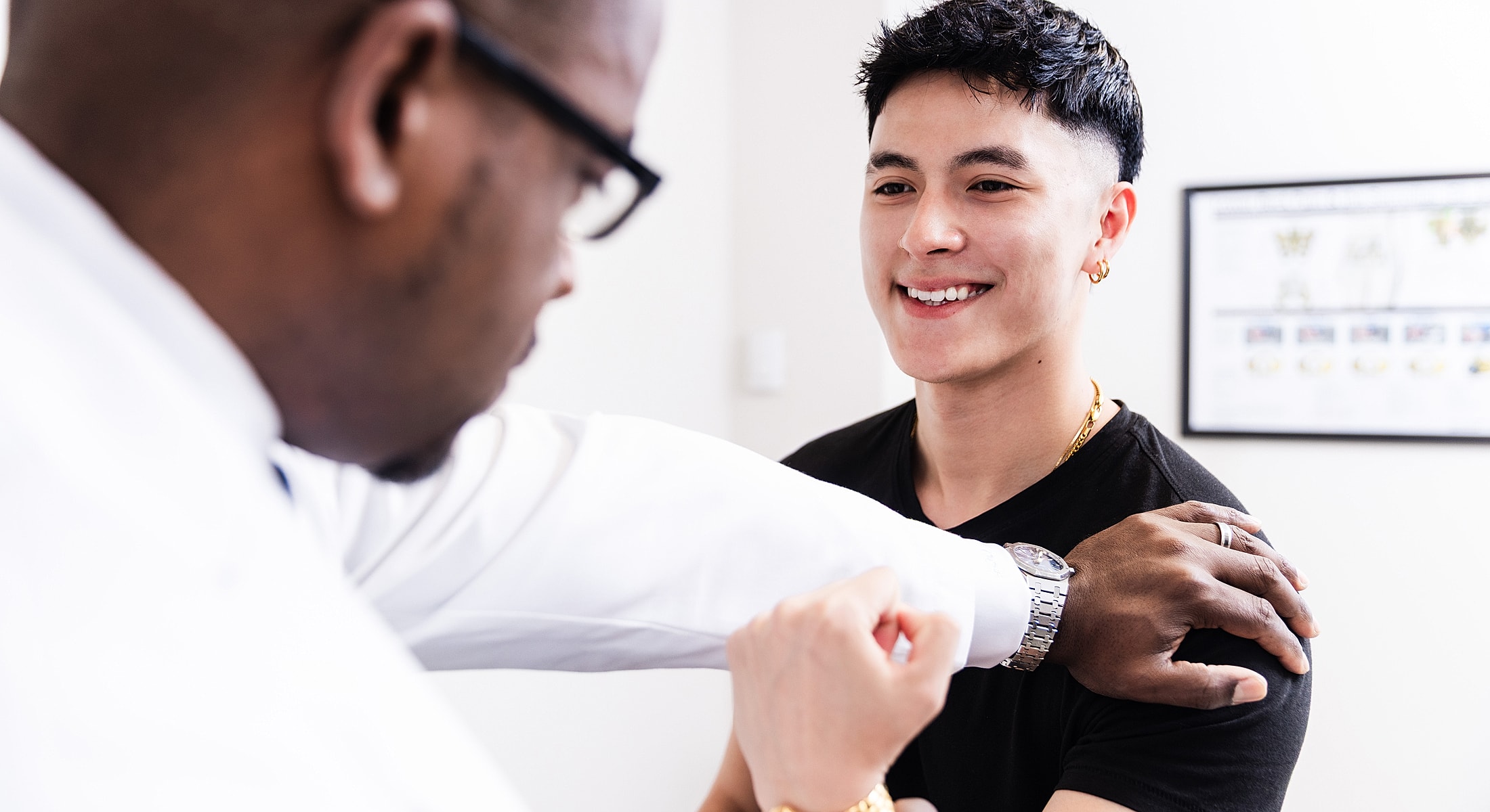 Doctor examining patient in medical office setting.